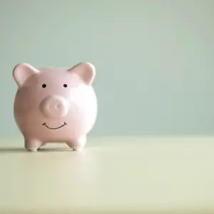 piggy bank on a table with a green background