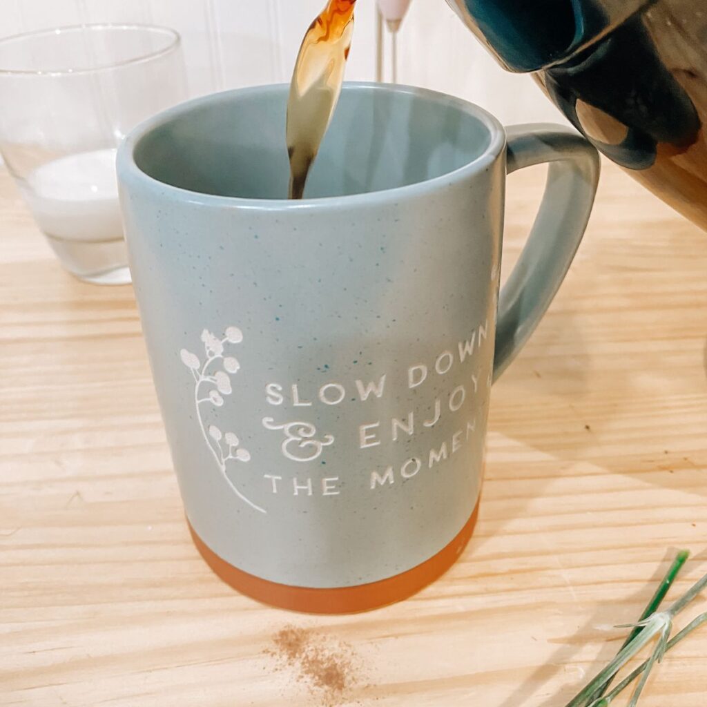 pouring coffee into a mug to make copycat starbucks mocha latte